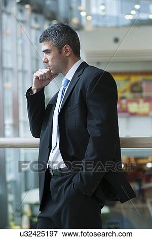 Businessman with serious expression looking off camera View Large Photo Image Stock Photo - Businessman with serious expression looking off camera. Fotosearch