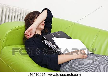 Picture - Businesswoman sleeping on a sofa. Fotosearch