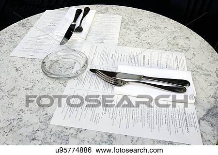 Stock Photograph - Café table with cutlery and menus. Fotosearch