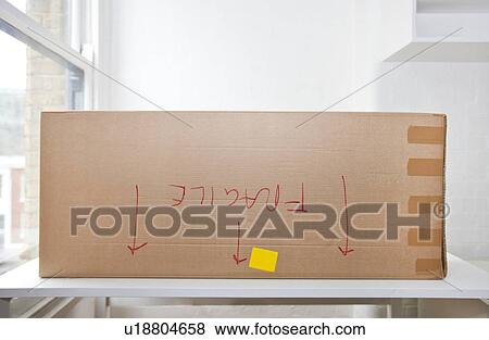 Stock Photo - Cardboard box marked "fragile" upside down. Fotosearch