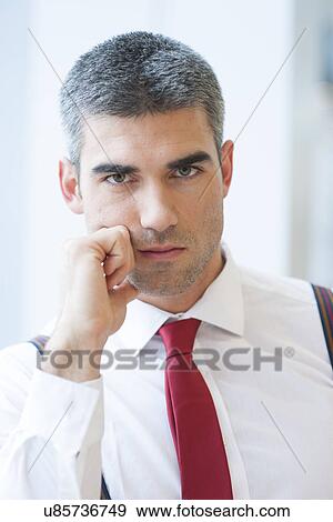 Stock Photo - Close-up of Businessman looking seriously at camera. Fotosearch