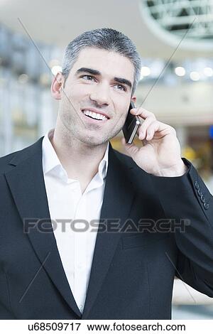 Stock Photo - Close-up of businessman on mobile phone. Fotosearch