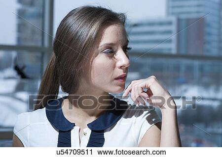 Stock Image - Close-up of businesswoman looking off camera. Fotosearch