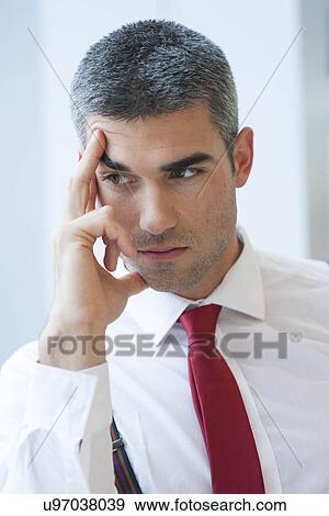 Close-up of pensive Businessman looking off camera View Large Photo Image Stock Photo - Close-up of pensive Businessman looking off camera. Fotosearch