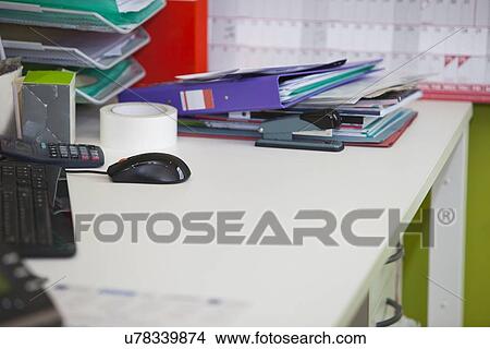 Close-up of real life messy desk in office View Large Photo Image Picture - Close-up of real life messy desk in office. Fotosearch