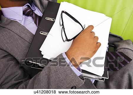 Close up of sleeping businessmans hand holding folder View Large Photo Image Stock Photo - Close up of sleeping businessmans hand holding folder. Fotosearch