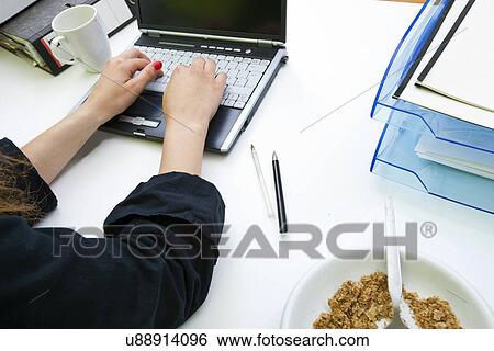 Close up of womans hands typing on laptop with folders and mug View Large Photo Image Stock Photograph - Close up of womans hands typing on laptop with folders and mug. Fotosearch