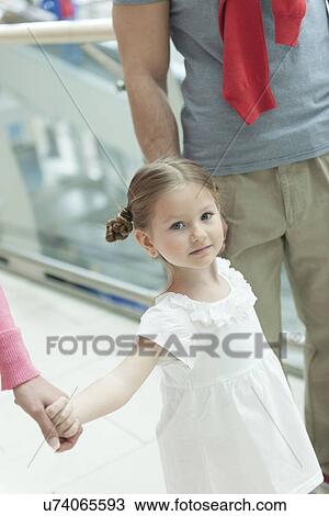 Close-up of young girl holding parents hands View Large Photo Image Stock Image - Close-up of young girl holding parents hands . Fotosearch