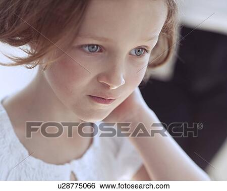 Stock Photograph - Close-up portrait of young girl looking away from camera. Fotosearch