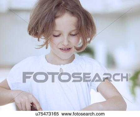 Close-up portrait of young girl chopping food in kitchen View Large Photo Image Stock Photography - Close-up portrait of young girl chopping food in kitchen. Fotosearch