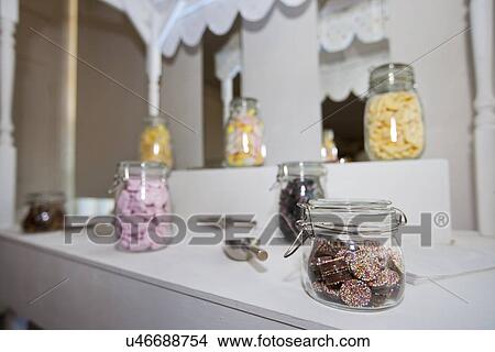 Picture - Close-up view of confectionary in glass jars. Fotosearch