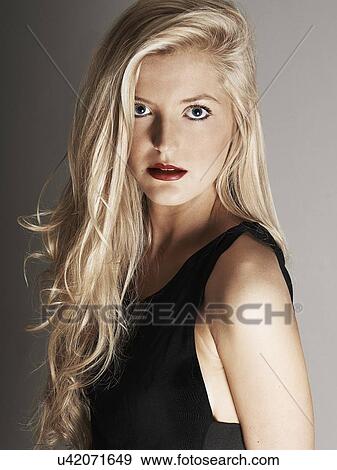 Close-up view of pretty blonde woman looking at camera View Large Photo Image Stock Photo - Close-up view of pretty blonde woman looking at camera. Fotosearch