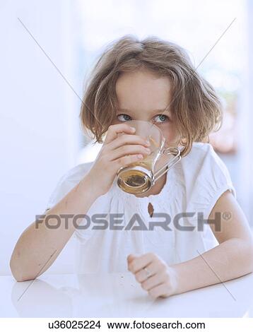 Picture - Close-up view of Young girl drinking cup of tea. Fotosearch