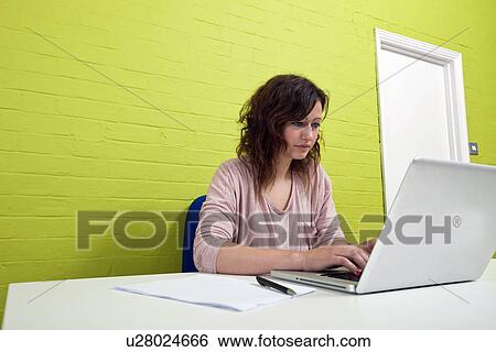 Close-up view of Young woman working at her desk View Large Photo Image Stock Photograph - Close-up view of Young woman working at her desk. Fotosearch