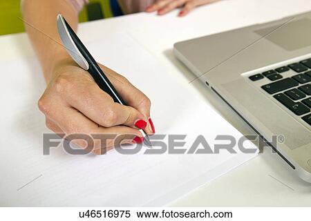 Close-up view of young womans hand writing on paper View Large Photo Image Stock Photography - Close-up view of young womans hand writing on paper. Fotosearch
