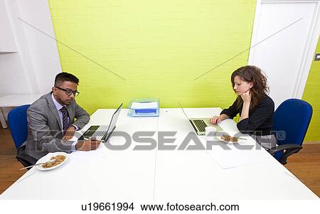 Colleagues working at their desks View Large Photo Image Picture - Colleagues working at their desks. Fotosearch