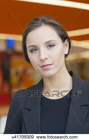 Stock Photo - Contemplative businesswoman looking at camera. Fotosearch