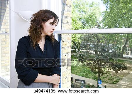 Stock Photography - Contemplative businesswoman looking out the window. Fotosearch