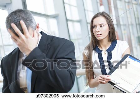 Stock Photography - Defeated businessman turns away form coworker. Fotosearch