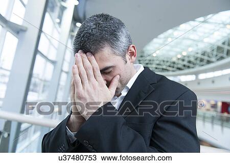 Disappointed businessman with head in hands View Large Photo Image Stock Image - Disappointed businessman with head in hands. Fotosearch