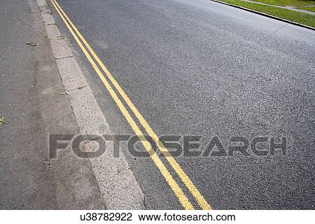 Stock Image - Double yellow line on London street. Fotosearch