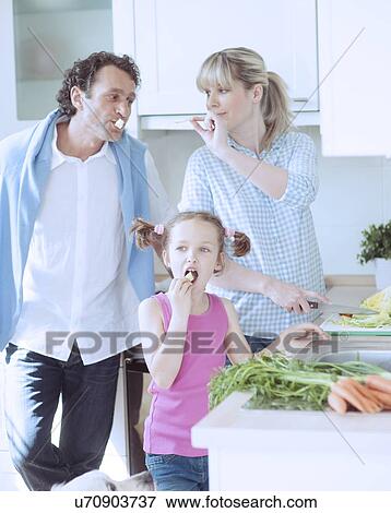 Family making a healthy salad in the kitchen View Large Photo Image Stock Photo - Family making a healthy salad in the kitchen. Fotosearch