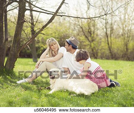 Family sitting in park with dog View Large Photo Image Stock Photography - Family sitting in park with dog. Fotosearch