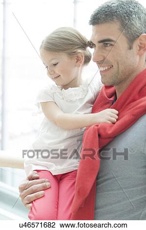 Father holding young daughter up at waist height View Large Photo Image Stock Image - Father holding young daughter up at waist height. Fotosearch
