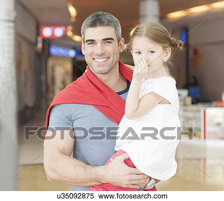 Father holding young daughter up at waist height View Large Photo Image Stock Photography - Father holding young daughter up at waist height. Fotosearch