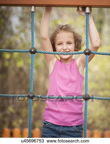 Half-length shot of young girl on climbing net View Large Photo Image Stock Image - Half-length shot of young girl on climbing net. Fotosearch