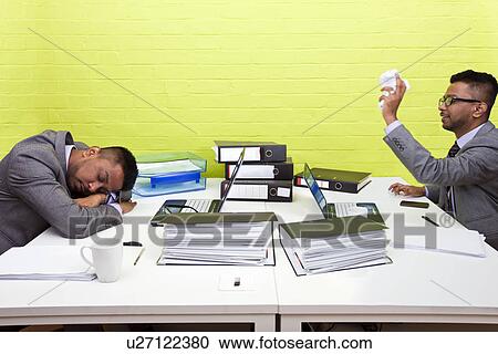 Indian businessman throwing paper at his sleeping twin View Large Photo Image Stock Image - Indian businessman throwing paper at his sleeping twin. Fotosearch