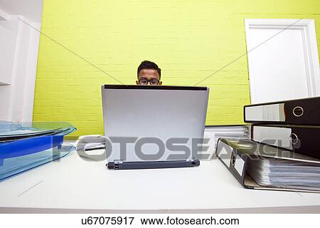 Mans head poking out over top of laptop View Large Photo Image Stock Photo - Mans head poking out over top of laptop. Fotosearch