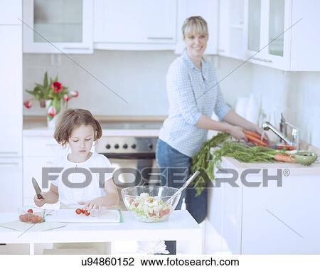 Mother and Daughter (8-9) preparing healthy meal in kitchen View Large Photo Image Stock Image - Mother and Daughter (8-9) preparing healthy meal in kitchen. Fotosearch