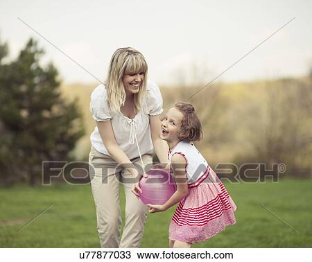 Mother and daughter playing with ball in the park View Large Photo Image Stock Image - Mother and daughter playing with ball in the park. Fotosearch