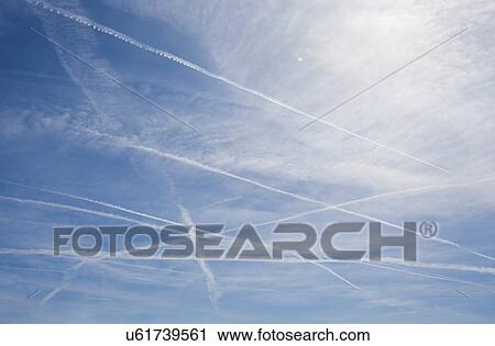 Stock Image - Multiple Jet Streams on Blue Sky. Fotosearch