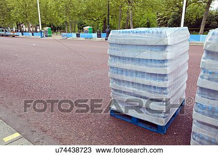 Stock Image - Pallet of water bottles ready for distribution. Fotosearch
