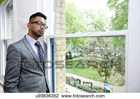 Portrait of Indian Businessman wearing glasses standing by the window View Large Photo Image Stock Image - Portrait of Indian Businessman wearing glasses standing by the window. Fotosearch