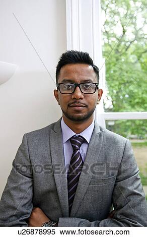 Portrait of Indian Businessman wearing glasses with hands folded View Large Photo Image Stock Photography - Portrait of Indian Businessman wearing glasses with hands folded. Fotosearch