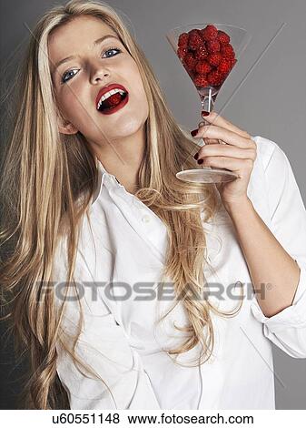Pretty blonde girl holding glass of raspberries View Large Photo Image Stock Photo - Pretty blonde girl holding glass of raspberries. Fotosearch