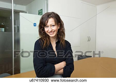 Proud businesswoman sitting in her board room View Large Photo Image Stock Image - Proud businesswoman sitting in her board room. Fotosearch