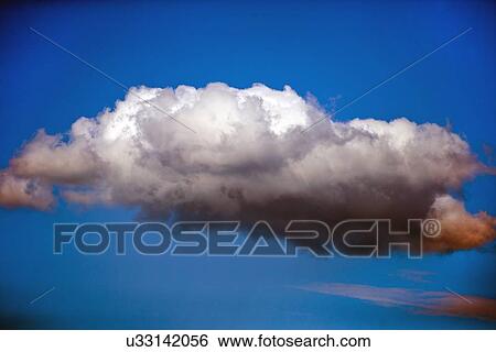Stock Photograph - Single cloud against blue sky. Fotosearch