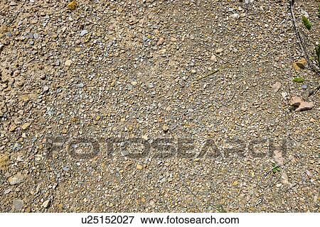 Stock Photo - Small stones, gravel, and red dirt. Fotosearch