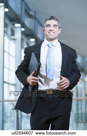 Stock Photo - Smiling businessman runs towards camera. Fotosearch