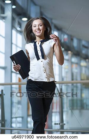 Smiling businesswoman runs towards camera View Large Photo Image Stock Image - Smiling businesswoman runs towards camera. Fotosearch