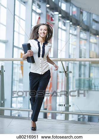 Smiling businesswoman runs towards camera View Large Photo Image Stock Image - Smiling businesswoman runs towards camera. Fotosearch