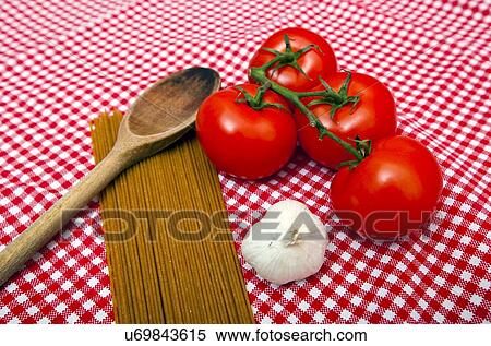 Stock Photography - Spaghetti, Garlic and Tomato home cooking ingredients. Fotosearch