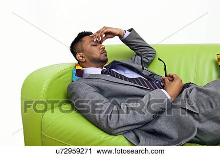Stressed business man holding the bridge of his nose View Large Photo Image Stock Image - Stressed business man holding the bridge of his nose. Fotosearch