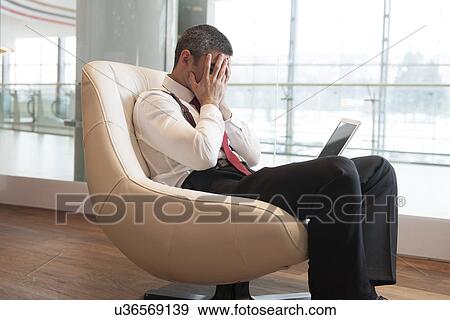 Stressed out businessman covers face with hands View Large Photo Image Stock Photo - Stressed out businessman covers face with hands. Fotosearch