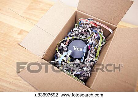Stock Image - Wooden block with the word Yes wrapped in a box. Fotosearch