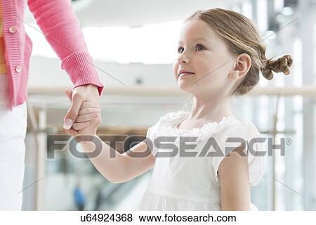 Young daughter holding mothers hand View Large Photo Image Stock Photo - Young daughter holding mothers hand. Fotosearch